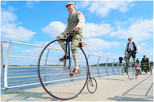 riding a penny farthing